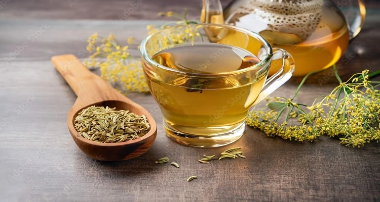 Your Natural Health - A cup of fennel tea with fennel seeds and a rustic background.